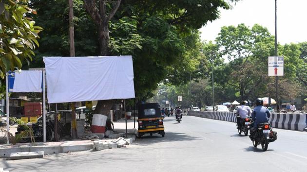 Due to the implementation of the model code of conduct, sign boards and hoardings in various parts of the city have been covered.(HT PHOTO)