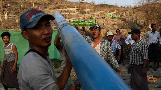 “The fire’s a really good sign -- it means there’s lots of oil here,” Khin Maung Htay told AFP as he scouted around the site just hours after a blaze was extinguished.The teams live right next to the wells in bamboo huts and tarpaulin tents offering some protection from the searing heat. (Ye Aung Thu / AFP) “The fire’s a really good sign -- it means there’s lots of oil here,” Khin Maung Htay told AFP as he scouted around the site just hours after a blaze was extinguished.The teams live right next to the wells in bamboo huts and tarpaulin tents offering some protection from the searing heat. (Ye Aung Thu / AFP)