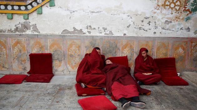 Buddhist monks rest outside a prayer hall between chanting sessions at Rongwo Monastery in the largely ethnic Tibetan town of Rebkong, Qinghai province, China. (Thomas Peter / REUTERS) Buddhist monks rest outside a prayer hall between chanting sessions at Rongwo Monastery in the largely ethnic Tibetan town of Rebkong, Qinghai province, China. (Thomas Peter / REUTERS)