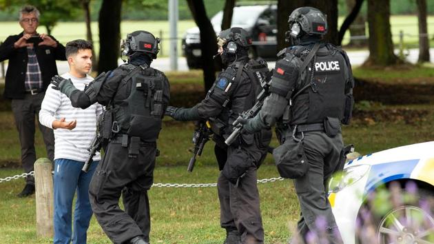 AOS (Armed Offenders Squad) push back members of the public in Christchurch. “Many of those who would have been affected by this shooting may be migrants to New Zealand,” Ardern said. “They may even be refugees here. They have chosen to make New Zealand their home and it is their home ... they are us. The persons who has perpetuated this violence against us ... have no place in New Zealand.” (Martin Hunter / SNPA / REUTERS) AOS (Armed Offenders Squad) push back members of the public in Christchurch. “Many of those who would have been affected by this shooting may be migrants to New Zealand,” Ardern said. “They may even be refugees here. They have chosen to make New Zealand their home and it is their home ... they are us. The persons who has perpetuated this violence against us ... have no place in New Zealand.” (Martin Hunter / SNPA / REUTERS)
