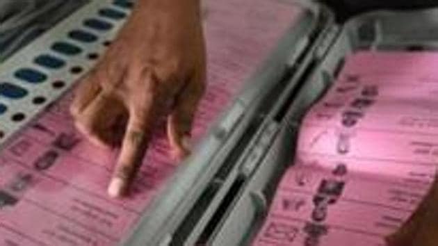 An election official tallies the names of candidates.(Arijit Sen/HT Photo)