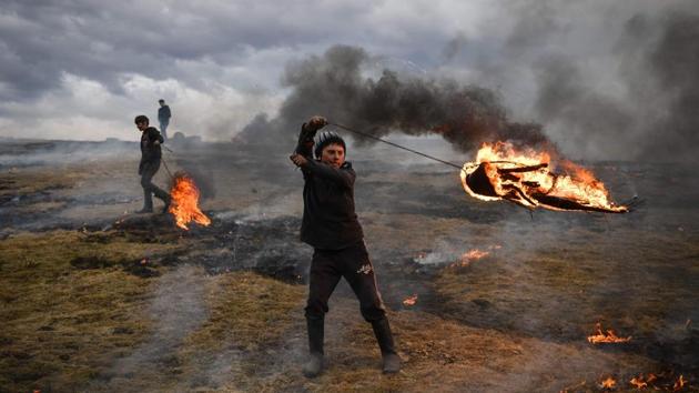 A youth spins a flaming tire as part of a tradition marking the upcoming Clean Monday, the first day of Great Lent in the Eastern Orthodox Christian church calendar, in the Romanian village of Poplaca. (Daniel Mihailescu / AFP) A youth spins a flaming tire as part of a tradition marking the upcoming Clean Monday, the first day of Great Lent in the Eastern Orthodox Christian church calendar, in the Romanian village of Poplaca. (Daniel Mihailescu / AFP)