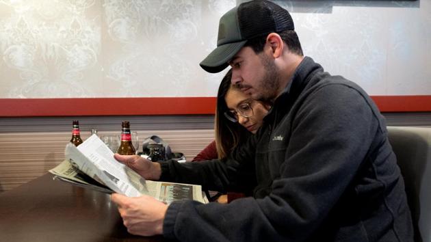 Jose Martinez, 31, and Arelis Morales read about the situation in Venezuela, in Spanish newspapers at a bar called ‘Caracas’ in Xinzo de Limia. But after years of opposing President Nicolas Maduro’s increasingly repressive government - including 2017 protests that ended with 125 deaths - they decided to put family life first. (Ana Maria Arevalo Gosen / REUTERS) Jose Martinez, 31, and Arelis Morales read about the situation in Venezuela, in Spanish newspapers at a bar called ‘Caracas’ in Xinzo de Limia. But after years of opposing President Nicolas Maduro’s increasingly repressive government - including 2017 protests that ended with 125 deaths - they decided to put family life first. (Ana Maria Arevalo Gosen / REUTERS)