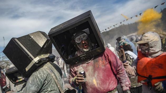 Revellers use old TVs as masks as they participate in a colourful ‘flour war’ during ‘Ash Monday’ celebrations, in the port town of Galaxidi, Greece. (Aris Messinis / AFP) Revellers use old TVs as masks as they participate in a colourful ‘flour war’ during ‘Ash Monday’ celebrations, in the port town of Galaxidi, Greece. (Aris Messinis / AFP)