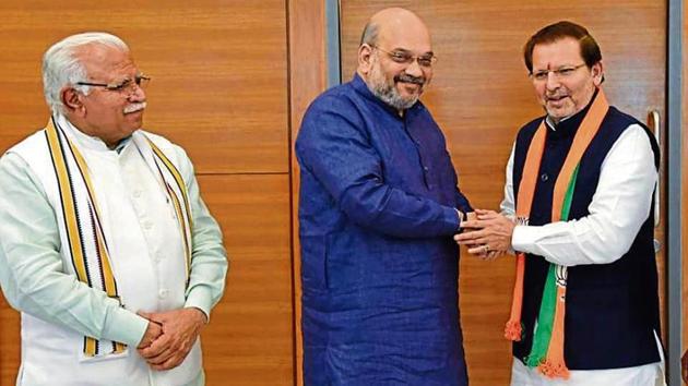 Former MP Arvind Sharma (right) with BJP national president Amit Shah and Haryana chief minister Manohar Lal Khattar in New Delhi on Friday (HT) Former MP Arvind Sharma (right) with BJP national president Amit Shah and Haryana chief minister Manohar Lal Khattar in New Delhi on Friday (HT)