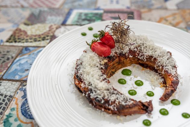 Parmigiana di melanzane are slices of fried aubergine layered with thick tomato paste, basil and baked with Parmesan on top