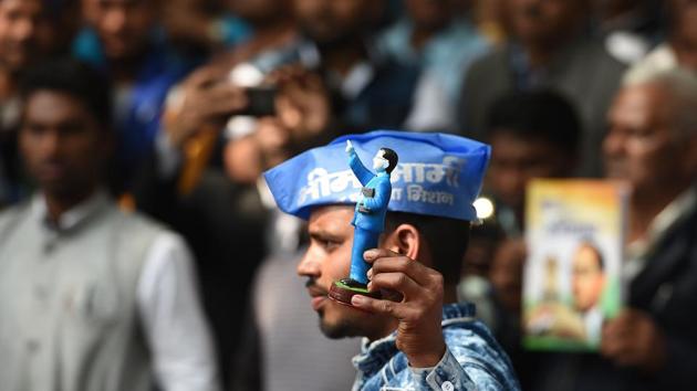 A Bhim Army supporter holds a figure of Bhim Rao Ambedkar during a rally on the occasion of late political leader Kanshi Ram’s 85th birthday, at Jantar Mantar, in New Delhi. (Raj K Raj / HT Photo) 