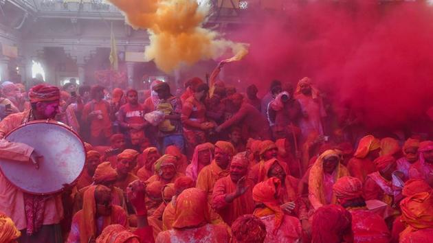 People play gulal or coloured powders during ‘Laddu Holi’ at Radha Rani Temple in Barsana of Mathura district, Uttar Pradesh. (Kamal Kishore / PTI) 