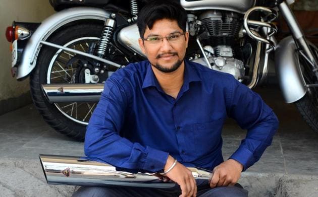 Karan Sarsar, poses with his bike exhaust muffler.(Shankar Narayan/HT PHOTO)