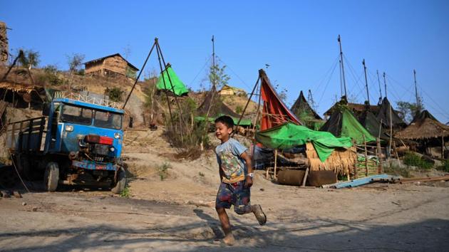 Many even bring their families along for their nomadic life. Children run around the hillsides dodging motorbikes and trucks transporting barrels of oil, while a handful of restaurants and tea shops serve the transient population of several thousand. (Ye Aung Thu / AFP) Many even bring their families along for their nomadic life. Children run around the hillsides dodging motorbikes and trucks transporting barrels of oil, while a handful of restaurants and tea shops serve the transient population of several thousand. (Ye Aung Thu / AFP)