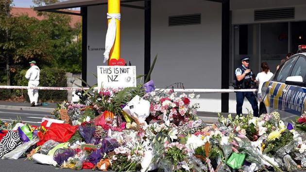 Residents pay respect by placing flowers for the victims of the mosques attacks in Christchurch on March 16, 2019.(AFP)