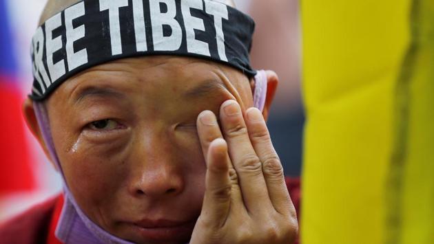 A Tibetan nun cries as she attends a protest held to mark the 60th anniversary of the Tibetan uprising against Chinese rule, in New Delhi. (Adnan Abidi / REUTERS) 