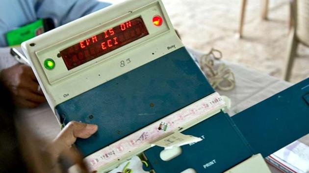 An election official checks an EVM at a counting centre.(AFP photo)
