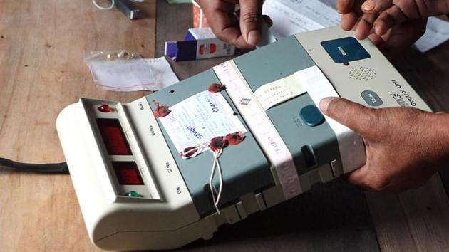 Election Commission officials seal an Electronic Voting Machine (EVM) .(AFP photo)