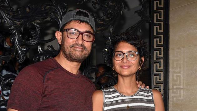 Aamir Khan along with his wife, film director and screenwriter Kiran Rao Khan, pose for photographs on his 54th birthday at his residence in Mumbai on March 14, 2019.(AFP)