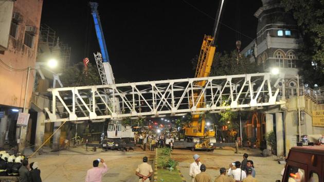 Workers dismantle the bridge near Chhatrapati Shivaji Maharaj Terminus on Friday, a day after its part collapsed.(Bhushan Koyande/HT File Photo) Workers dismantle the bridge near Chhatrapati Shivaji Maharaj Terminus on Friday, a day after its part collapsed.(Bhushan Koyande/HT File Photo)
