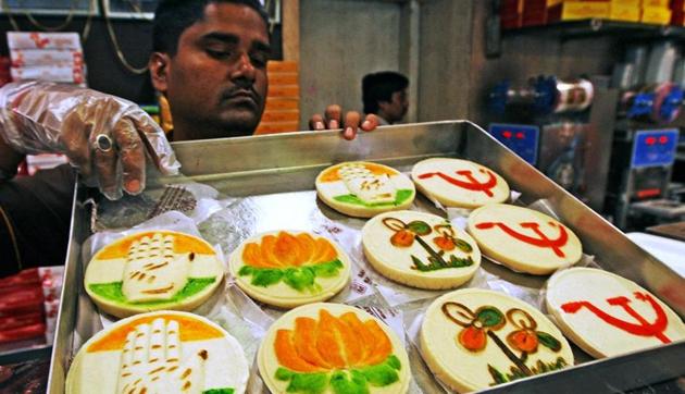 A shopkeeper displays his sweets with different political party symbol ahead of upcoming Lok Sabha poll in Kolkata.(PTI File Photo)