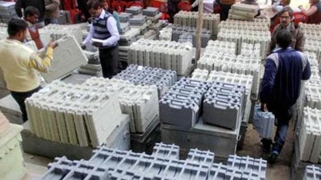 Polling officers collect electronic voting machines(EVM) and polling material before an election.(PTI)
