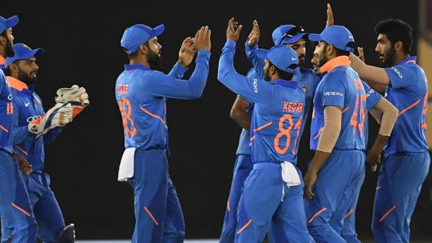 India cricketers celebrate the wicket of Australia cricketer Usman Khawaja.(AFP)