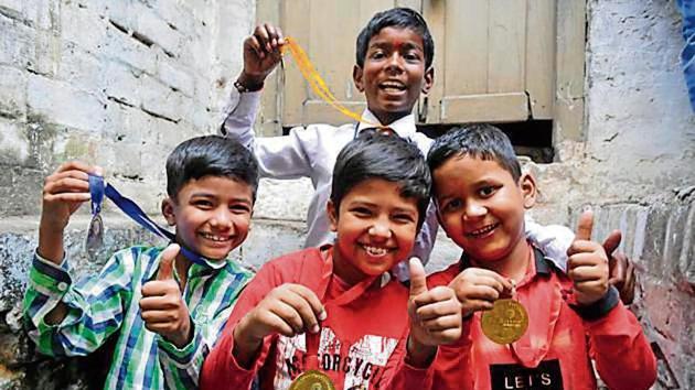 Ali Ahmad (centre), Saksham (right), Abdullah (left) and Krishna (back) – students who did well in their exams.(Deepak Gupta/HT Photo)