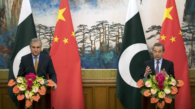 Chinese foreign minister Wang Yi with his Pakistani counterpart Shah Mahmood Qureshi during a joint press conference at the Diaoyutai State Guesthouse in Beijing on March 19.(AP Photo)