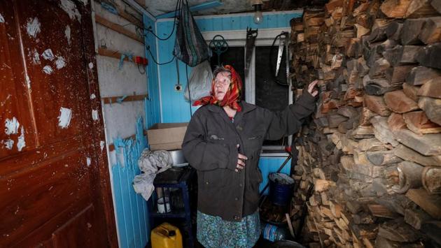 Raisa Taranenko looks at bullet holes in door caused by shelling and points at self-made protecting wall made of firewood in her house. Taranenko wants an end to the war. "But it's not clear how the situation will develop. There is no hope for anything", she said. "Everything is getting worse and worse." (Gleb Garanich / REUTERS) Raisa Taranenko looks at bullet holes in door caused by shelling and points at self-made protecting wall made of firewood in her house. Taranenko wants an end to the war. "But it's not clear how the situation will develop. There is no hope for anything", she said. "Everything is getting worse and worse." (Gleb Garanich / REUTERS)