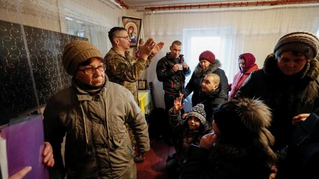 A chaplain leads service in Zaitseve. Poroshenko’s main rivals, former Prime Minister Yulia Tymoshenko and comic actor Volodymyr Zelenskiy, say they will approach peace talks differently, bringing the US and other countries on board. But it is unclear whether they would change the status quo. Residents in Zaitseve were reluctant to reveal their voting intentions but Zelenskiy leads recent opinion polls. (Gleb Garanich / REUTERS) A chaplain leads service in Zaitseve. Poroshenko’s main rivals, former Prime Minister Yulia Tymoshenko and comic actor Volodymyr Zelenskiy, say they will approach peace talks differently, bringing the US and other countries on board. But it is unclear whether they would change the status quo. Residents in Zaitseve were reluctant to reveal their voting intentions but Zelenskiy leads recent opinion polls. (Gleb Garanich / REUTERS)