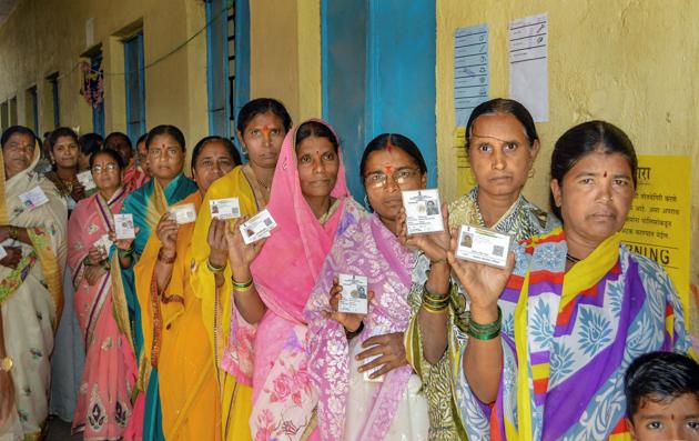 Karad: Voters show their identity cards as they stand in a queue at a polling station to cast their vote for the Gram Panchayat elections at Masur village, in Karad, Sunday, Feb. 24, 2019.(PTI)