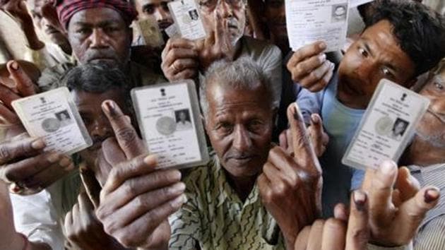 Voters show their ink marks after having cast their vote.(Raj K Raj/HT Photo)