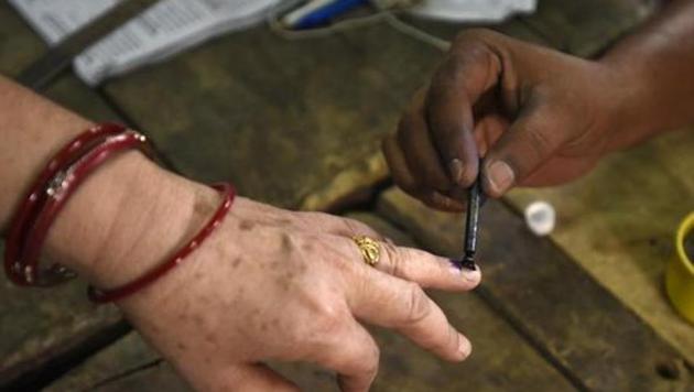 New Delhi, India-April 23, 2017: A man Ink mark a voter finger during the casting her vote for the MCD election 2017, in polling station no. 50, in East Delhi, India on Sunday, April 23, 2017.(Sonu Mehta/HT PHOTO)