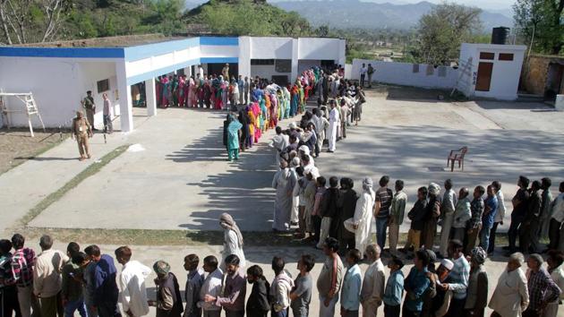 Voters stand in a queue to cast their votes at a polling station during parliamentary elections in Jammu, India, on Thursday, April 10, 2014. Millions of people are voting in the third phase of the elections Thursday, covering parts of 11 of India's 28 states. The multiphase voting across the country runs until May 12, with results for the 543-seat lower house of parliament announced May 16.(Nitin Kanotra / HT Archive)