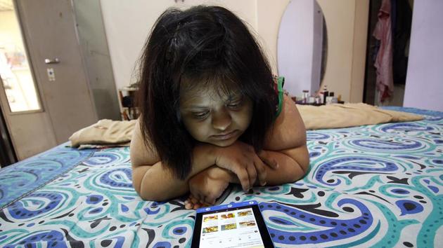 Aditi pores over food videos at home, to experiment with later. “Aditi’s growth was slow. She went through an open heart surgery when she was two. She walked slowly, her speech was unclear. We sent her to a regular school, but realised the teachers can’t give her attention. Other kids didn’t want to play with her. We then shifted her to a special school, which worked well,” her mother recounted. (Hemanshi Kamani / HT Photo) Aditi pores over food videos at home, to experiment with later. “Aditi’s growth was slow. She went through an open heart surgery when she was two. She walked slowly, her speech was unclear. We sent her to a regular school, but realised the teachers can’t give her attention. Other kids didn’t want to play with her. We then shifted her to a special school, which worked well,” her mother recounted. (Hemanshi Kamani / HT Photo)