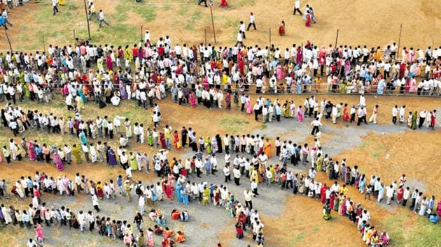 People stand in queues to cast their votes at a polling centre.(Manoj Patil / HT Photo)