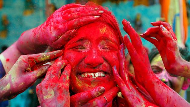 A woman reacts as devotees apply coloured powder on her face during celebrations outside a temple on the outskirts of Kolkata. While the festival is predominantly celebrated in India and Nepal, the festival, these days, is widely celebrated in other Asian and Western countries owing to the presence of Indian diaspora in these regions. (Rupak De Chowdhuri / REUTERS) A woman reacts as devotees apply coloured powder on her face during celebrations outside a temple on the outskirts of Kolkata. While the festival is predominantly celebrated in India and Nepal, the festival, these days, is widely celebrated in other Asian and Western countries owing to the presence of Indian diaspora in these regions. (Rupak De Chowdhuri / REUTERS)