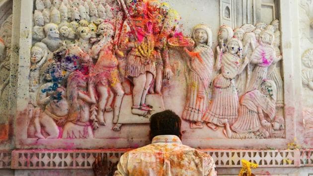 A devotee covered in coloured powder prays during Holi, at a temple in New Delhi. Festivities also include some lip-smacking sweets and savouries, as well as bhang- a customary drink made from cannabis. (Dominique Faget / AFP) A devotee covered in coloured powder prays during Holi, at a temple in New Delhi. Festivities also include some lip-smacking sweets and savouries, as well as bhang- a customary drink made from cannabis. (Dominique Faget / AFP)