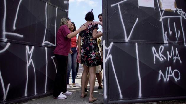 A student is received during a reopening day of the school, after a shooting in the Raul Brasil school in Suzano, Sao Paulo state, Brazil. (Ueslei Marcelino / REUTERS) A student is received during a reopening day of the school, after a shooting in the Raul Brasil school in Suzano, Sao Paulo state, Brazil. (Ueslei Marcelino / REUTERS)