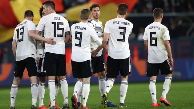 Germany's midfielder Leon Goretzka (C) celebrates with his teammates during their friendly match against Serbia.(AFP)