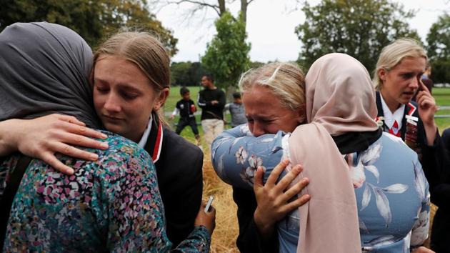 High school students from a Christian school embrace as they give hugs to Muslims waiting for news of their relatives at a community centre, following the shooting in Christchurch, New Zealand. (Jorge Silva / REUTERS) High school students from a Christian school embrace as they give hugs to Muslims waiting for news of their relatives at a community centre, following the shooting in Christchurch, New Zealand. (Jorge Silva / REUTERS)