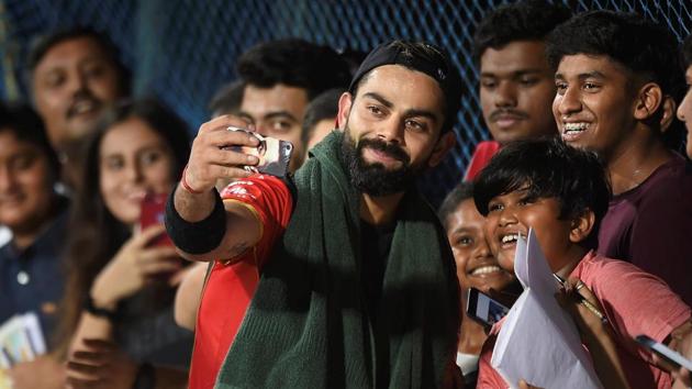 Chennai: Royal Challengers Bangalore (RCB) skipper Virat Kohli takes selfie with fans at a practice session.(PTI)