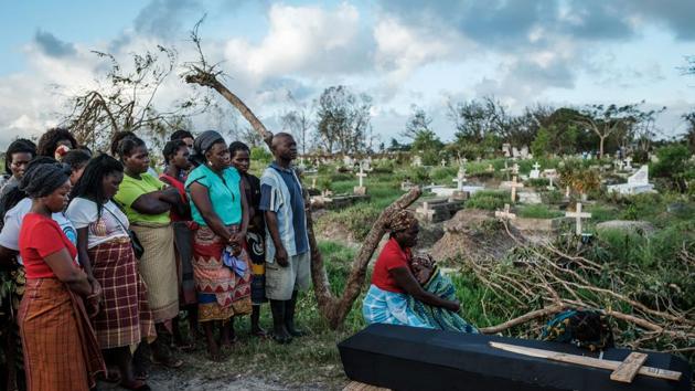 Rebecca Albino (R), a mother of three, mourns beside the coffin of her husband during his funeral, following tropical cyclone Idai which hit Beira, Mozambique. Cyclone Idai cut a swathe through Mozambique, Zimbabwe and Malawi. (Yasuyoshi Chiba / AFP) Rebecca Albino (R), a mother of three, mourns beside the coffin of her husband during his funeral, following tropical cyclone Idai which hit Beira, Mozambique. Cyclone Idai cut a swathe through Mozambique, Zimbabwe and Malawi. (Yasuyoshi Chiba / AFP)