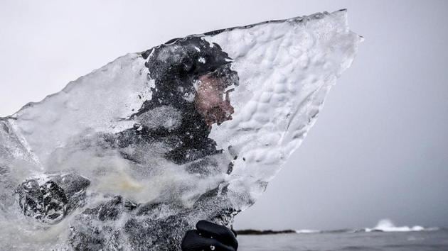 Swedish surfer Pontus Hallin walks into the water with his ice surfboard partly melted at the Delp surfing spot, near Straumnes, in the Lofoten Islands, over the Arctic Circle. (Olivier Morin / AFP) Swedish surfer Pontus Hallin walks into the water with his ice surfboard partly melted at the Delp surfing spot, near Straumnes, in the Lofoten Islands, over the Arctic Circle. (Olivier Morin / AFP)