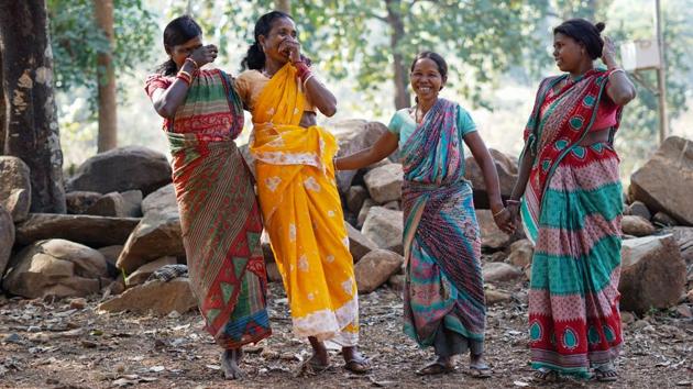 Women from the Bhuiya tribe, an indigenous community in Gadia village in Deogarh district, Odisha break into an impromptu dance and distribute sweets as the first hand pump is installed in their village this year in January. (WaterAid / Meenal Upreti)