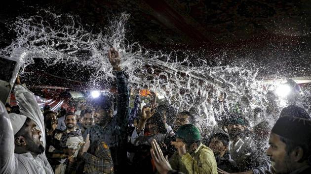 Devotees are showered with perfumed water at the shrine of Khwaja Moinuddin Chisti during the 807th Urs festival, in Ajmer, Rajasthan. (PTI) 