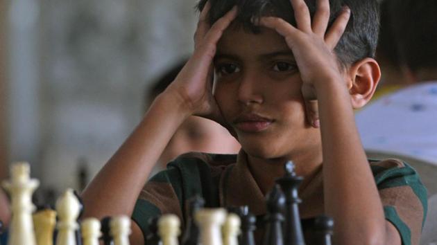 A competitor from Mumbai Suburban reacts during a match during the Late Shikshanmaharshi Shivajirao Konde Memorial Maharashtra State Selection Under-7 Girls and Boys Chess Championship at Khed Shivapur in Pune, Maharashtara. (Pratham Gokhale / HT Photo) 