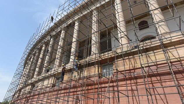 Workers scrub through the Parliament House facade in New Delhi. (Raj K Raj / HT Photo) 