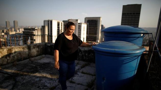 “We try to save water scrubbing ourselves standing in bowls,” said Yudith Contreras, a 49-year-old lawyer, in her apartment where little water has arrived over the past two years. She has taken to getting water from streams that run down the Avila mountain above Caracas. Contreras, in a ten-story housing complex in downtown Caracas, said her family recycles the water by using it to flush the toilet.  (Carlos Garcia Rawlins / REUTERS) 