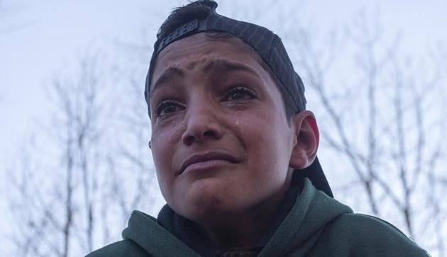 A boy wailing near the body of a 12 Year old boy Aatif Hussain Mir during his funeral procession in Mir Mohalla Hajin Bandipora district North Kashmir. The boy was killed during an encounter at his residence were militants had allegedly taken him hostage on Friday. (ANI Photo)(ANI) A boy wailing near the body of a 12 Year old boy Aatif Hussain Mir during his funeral procession in Mir Mohalla Hajin Bandipora district North Kashmir. The boy was killed during an encounter at his residence were militants had allegedly taken him hostage on Friday. (ANI Photo)(ANI)