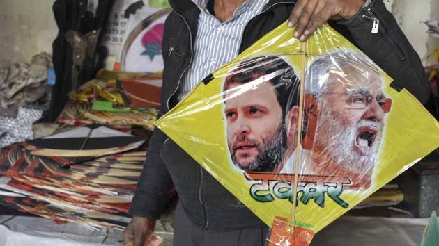 A kite maker shows a kite with images of Prime Minister Narendra Modi and Congress president Rahul Gandhi.(PTI file photo)