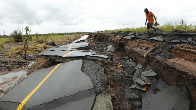 A man passes through a section of the road damaged by Cyclone Idai in Nhamatanda, about 50 kilometres from Beira. As flood waters began to recede in parts of Mozambique on Friday, fears rose that the death toll could soar as bodies are revealed. (Tsvangirayi Mukwazhi / AP) A man passes through a section of the road damaged by Cyclone Idai in Nhamatanda, about 50 kilometres from Beira. As flood waters began to recede in parts of Mozambique on Friday, fears rose that the death toll could soar as bodies are revealed. (Tsvangirayi Mukwazhi / AP)