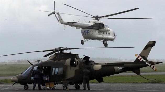 A World Food Programme (WFP) helicopter takes off in Beira. Mozambique. Helicopters and boats have been rescuing some people stranded for days on rooftops and trees. Some survivors have been digging through rubble with their bare hands to search for loved ones, while government and aid agencies have been flying in help. (Themba Hadebe / AP) A World Food Programme (WFP) helicopter takes off in Beira. Mozambique. Helicopters and boats have been rescuing some people stranded for days on rooftops and trees. Some survivors have been digging through rubble with their bare hands to search for loved ones, while government and aid agencies have been flying in help. (Themba Hadebe / AP)